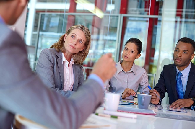 Professional attorneys meeting with client in modern conference room discussing legal case